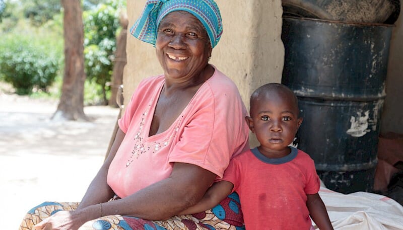 grandmother_and_grandson_next_to_house.800x0-is